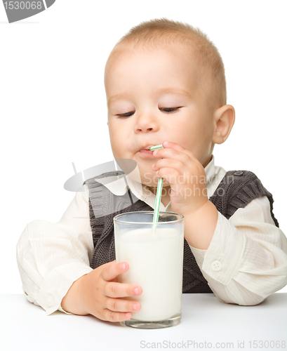 Image of Cute little boy is drinking milk