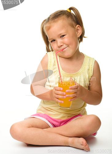 Image of Little girl drinks orange juice