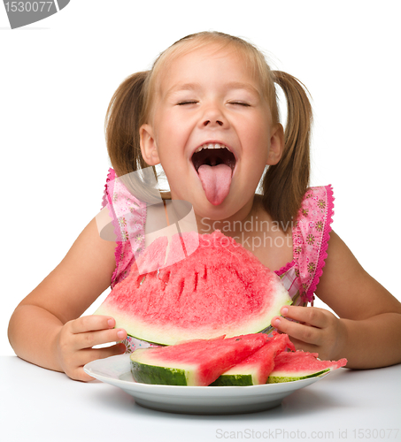 Image of Cute little girl is going to eat watermelon