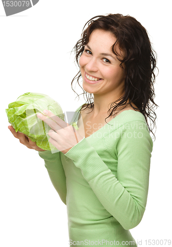 Image of Beautiful young girl with green cabbage