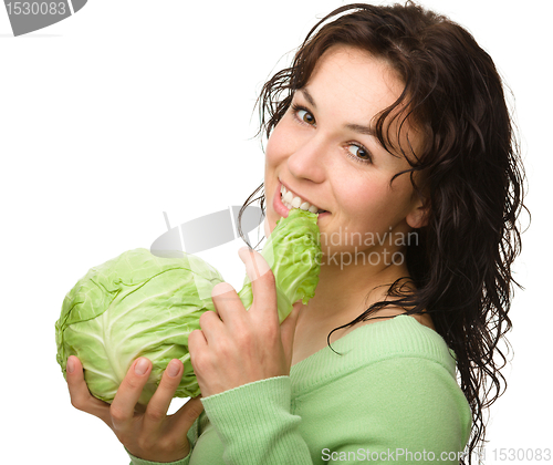 Image of Beautiful young girl with green cabbage