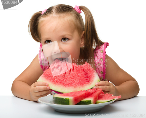 Image of Cute little girl is going to eat watermelon