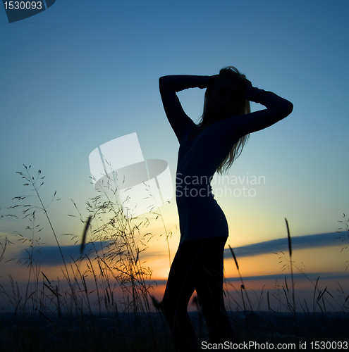 Image of Silhouette of a girl over sunset