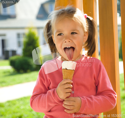 Image of Little girl is eating ice-cream