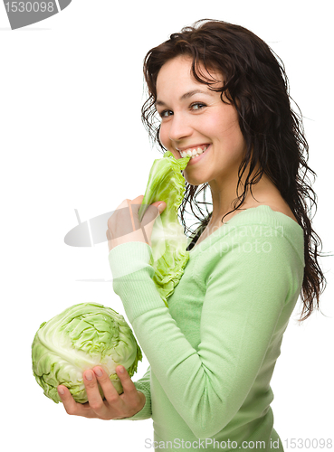 Image of Beautiful young girl with green cabbage