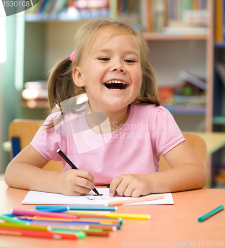 Image of Little girl is drawing with felt-tip pen