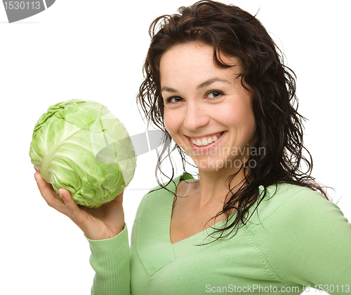 Image of Beautiful young girl with green cabbage