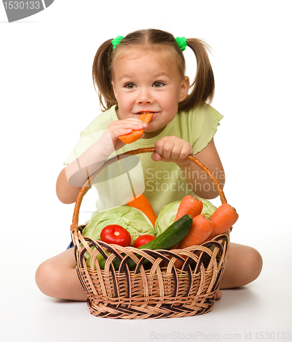 Image of Cute little girl eats carrot