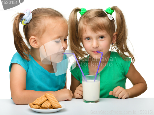 Image of Two little girls are drinking milk