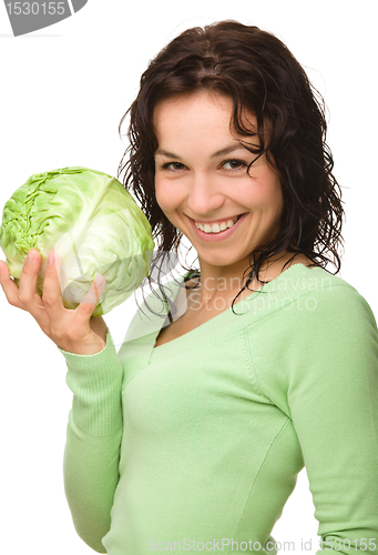 Image of Beautiful young girl with green cabbage