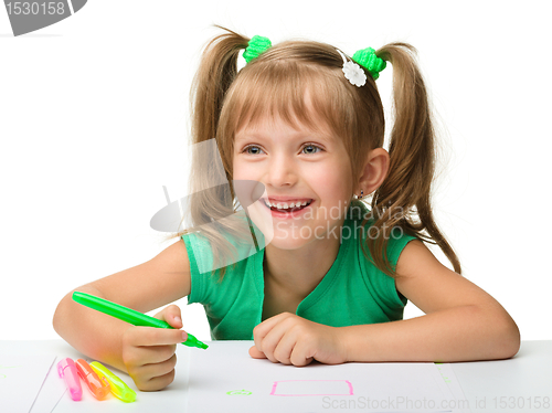 Image of Cute little girl draws with markers