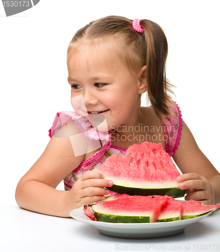 Image of Cute little girl is going to eat watermelon