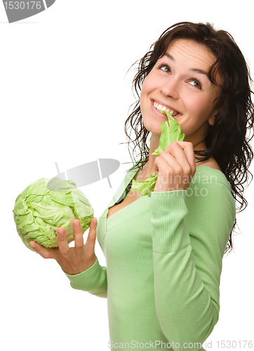 Image of Beautiful young girl with green cabbage