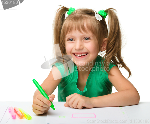 Image of Cute little girl draws with markers