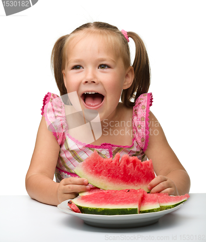 Image of Cute little girl is going to eat watermelon