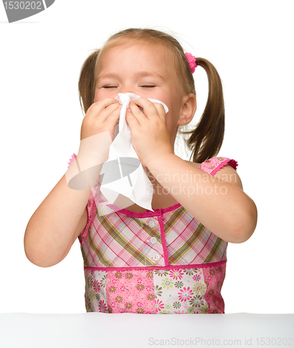 Image of Little girl blows her nose