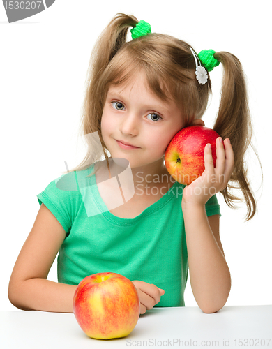 Image of Portrait of a little girl with two apples