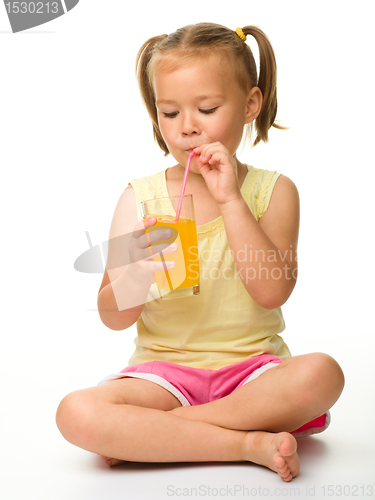 Image of Little girl drinks orange juice