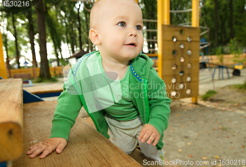 Image of Little boy is playing on playground