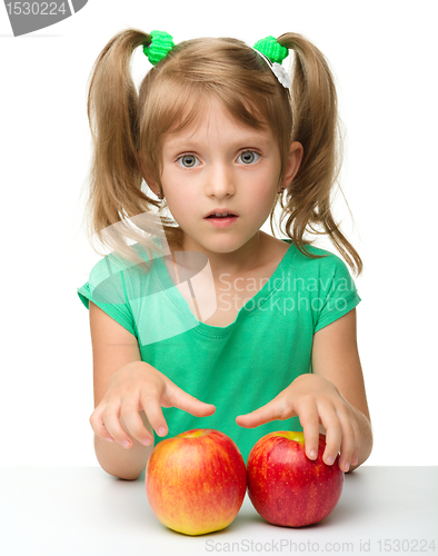 Image of Portrait of a little girl with apple