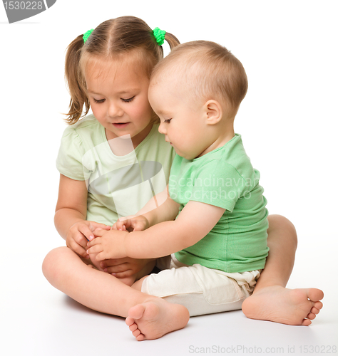 Image of Two children are playing on the floor