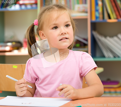 Image of Little girl is drawing with felt-tip pen