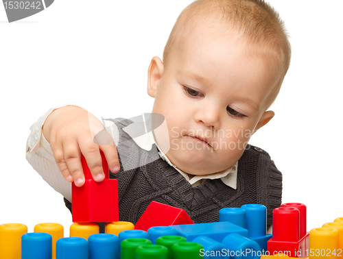 Image of Little boy plays with building bricks