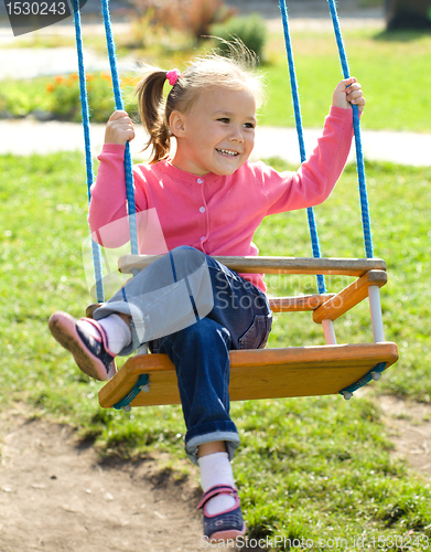 Image of Cute little girl on swing