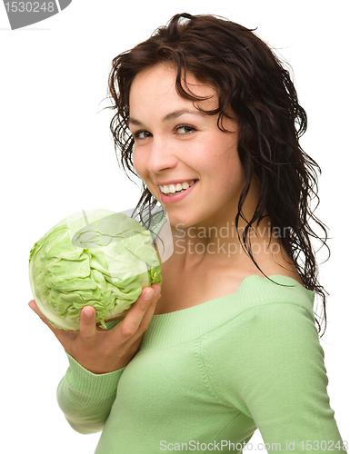Image of Beautiful young girl with green cabbage