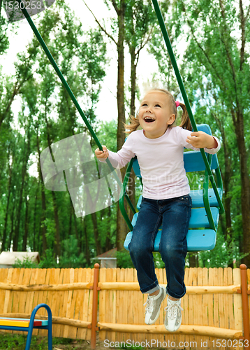 Image of Cute little girl on swing