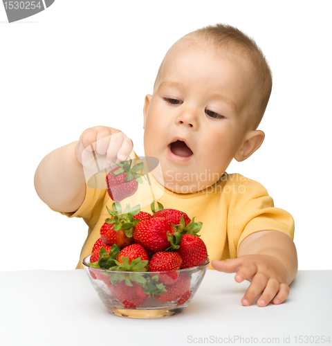 Image of Happy little boy with strawberries