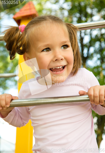 Image of Little girl is playing in playground