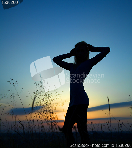 Image of Silhouette of a girl over sunset