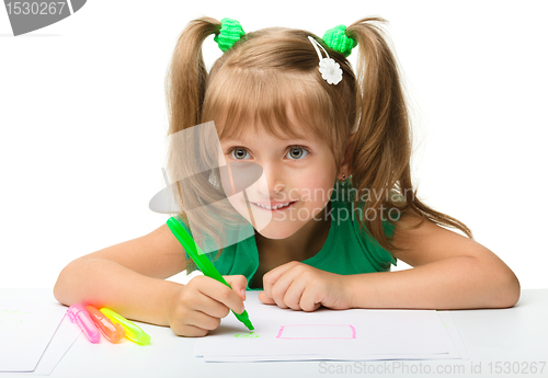 Image of Cute little girl draws with markers