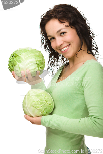 Image of Beautiful young girl with green cabbage
