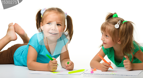 Image of Two little girls draw with markers