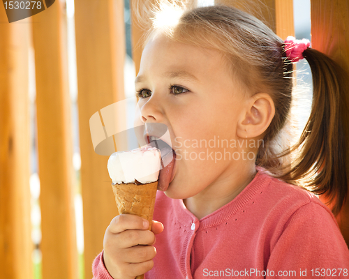 Image of Little girl is eating ice-cream