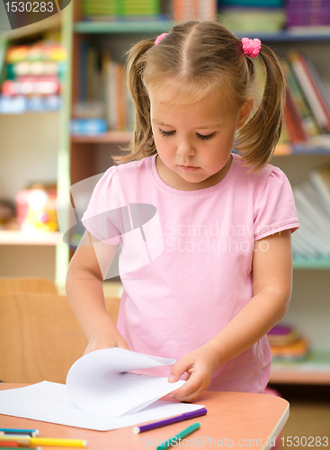 Image of Little girl is drawing with felt-tip pen