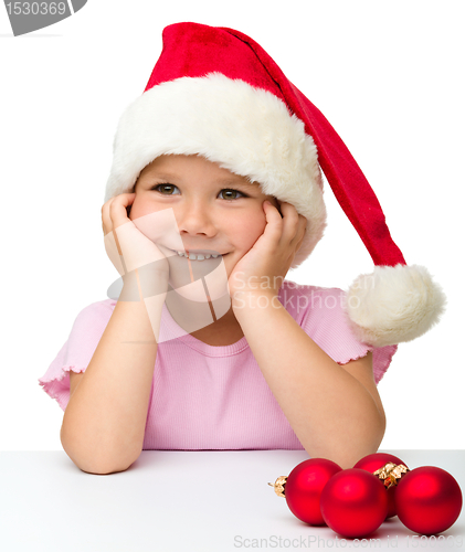 Image of Cute little girl wearing santa hat
