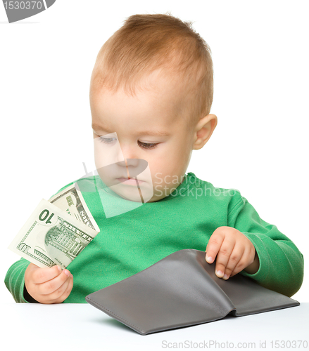 Image of Cute little boy is counting money