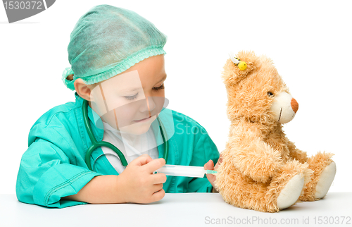 Image of Little girl is playing doctor with syringe