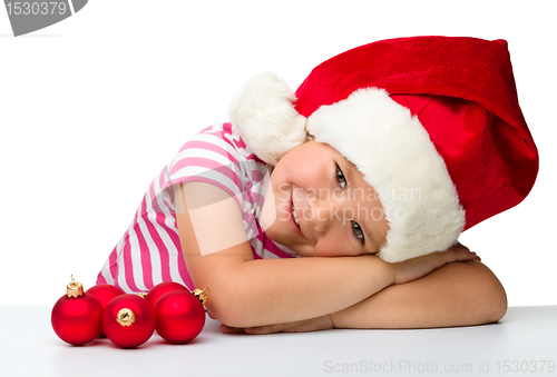 Image of Cute little girl wearing santa hat
