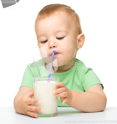 Image of Cute little boy is drinking milk