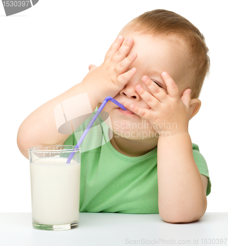Image of Cute little boy is drinking milk