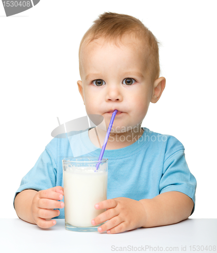 Image of Cute little boy is drinking milk