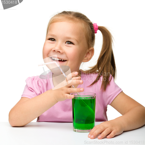 Image of Little girl with a glass of tarragon drink