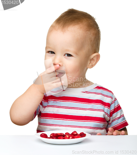 Image of Happy little boy with strawberries