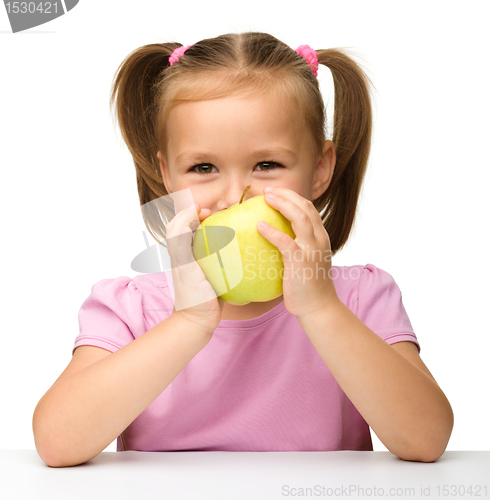Image of Little girl with yellow apple