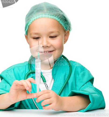 Image of Little girl is playing doctor with syringe