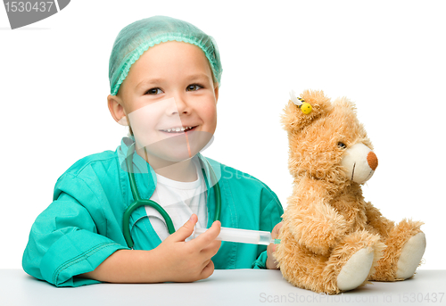 Image of Little girl is playing doctor with syringe
